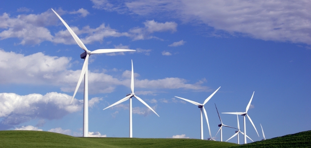 How do windmills create electricity based on wind speed